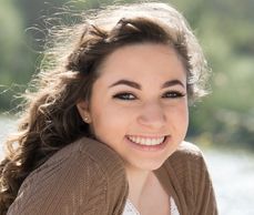 A woman in brown smiling