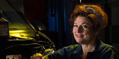 A woman mechanic holding a wrench