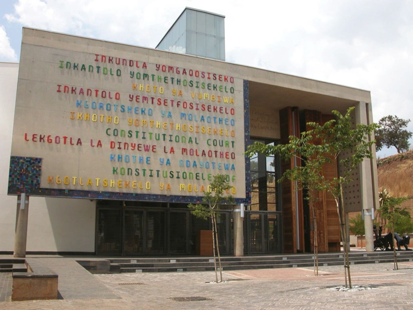 Modern building with colorful text about the Constitutional Court on its facade.