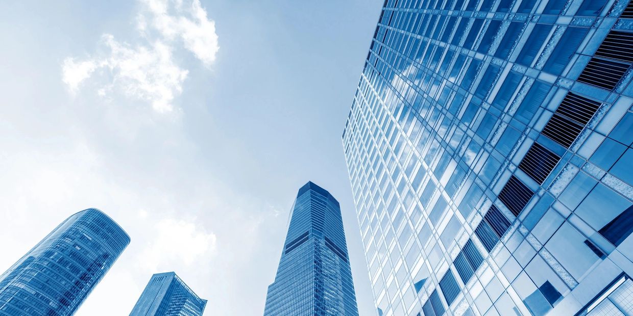 Modern skyscrapers under a blue sky.