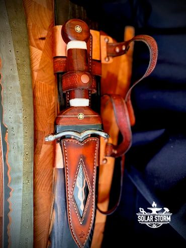 CuMai damascus Dagger in sheath on Kopis sword by Custom bladesmith in Alberta Canada