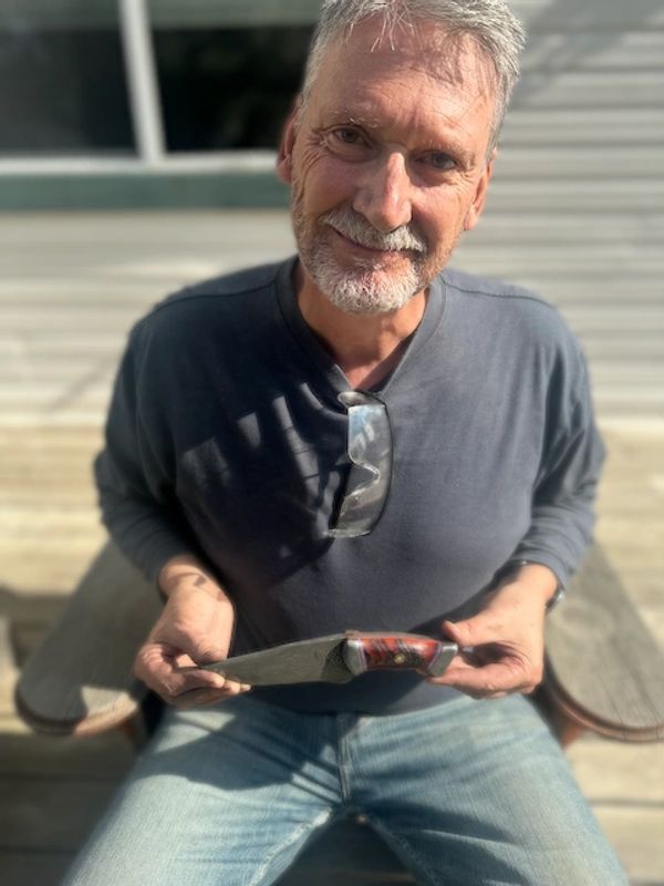 student with damascus knife