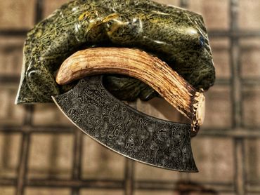 raindrop Damascus ulu with deer antler handle on soapstone