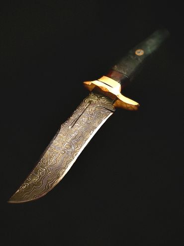 Damascus hunting bowie with burlwood and brass