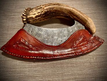 raindrop Damascus ulu with deer antler handle in sheath