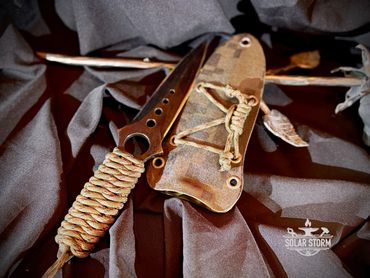 Tactical dagger by Custom Alberta Bladesmith complete with paracord handle and kydex sheath