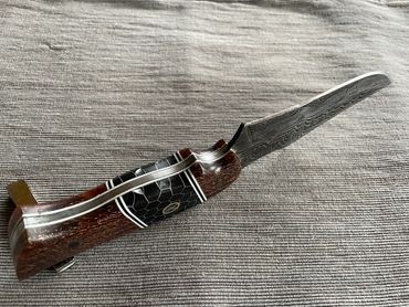 5" damascus hunting knife with copper accent epoxy handle