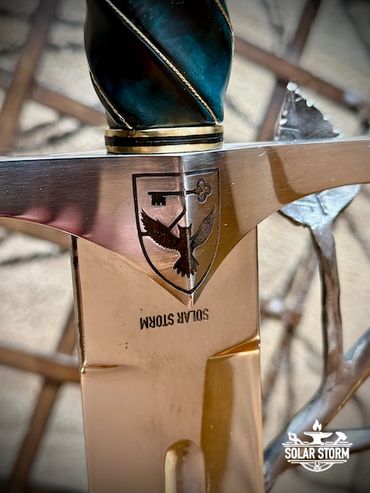 Arming Sword handle with Coat of Arms on the cross guard from custom bladesmith and blacksmith Solar
