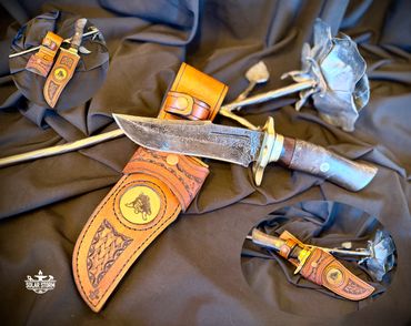 Damascus hunting bowie and brass with leather sheath Solar Storm Bladesmith Alberta Canada