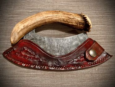 raindrop Damascus ulu with deer antler handle in sheath