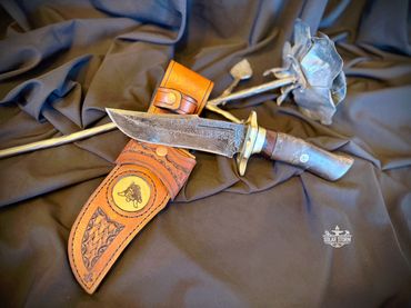 Damascus hunting bowie and brass with leather sheath Solar Storm Bladesmith Alberta Canada