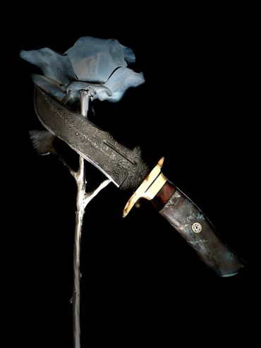 Damascus hunting bowie with burlwood and brass