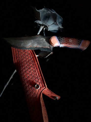 left sideDamascus CuMai hunting knife.  15n20 and 1084 copper shims epoxy dragon scales handle