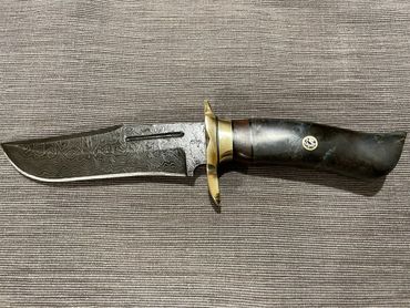 Damascus hunting bowie with burlwood and brass