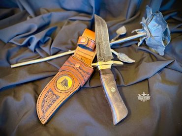 Damascus hunting bowie and brass with leather sheath Solar Storm Bladesmith Alberta Canada