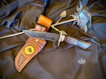 Damascus hunting bowie and brass with leather sheath Solar Storm Bladesmith Alberta Canada