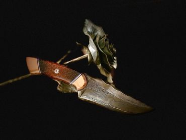 right side Damascus CuMai hunting knife.  15n20 and 1084 copper shims epoxy dragon scales handle