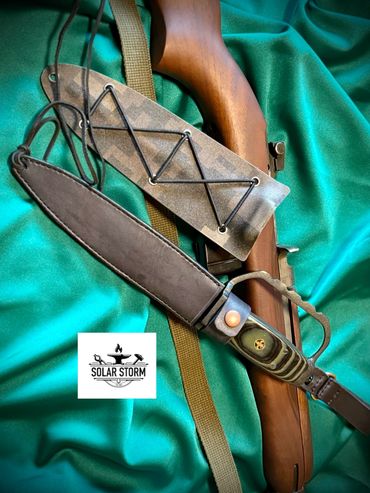 parkerized trench knife in leather sheath by custom alberta blacksmith and bladesmtih - solarstorm