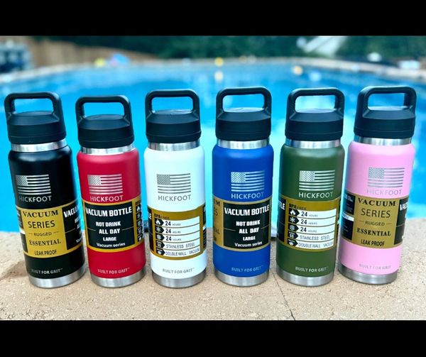 Six colorful Hickfoot vacuum bottles lined up by a pool.