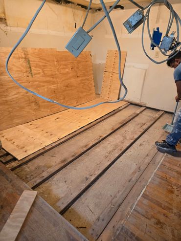 Applying plywall. Acuna Construction. Remodeling