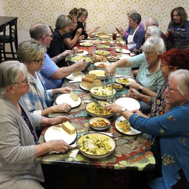 pasta class participants eating family style meal