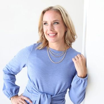 Elyse in a blue dress - she has experience as a senior leader in organizational change management