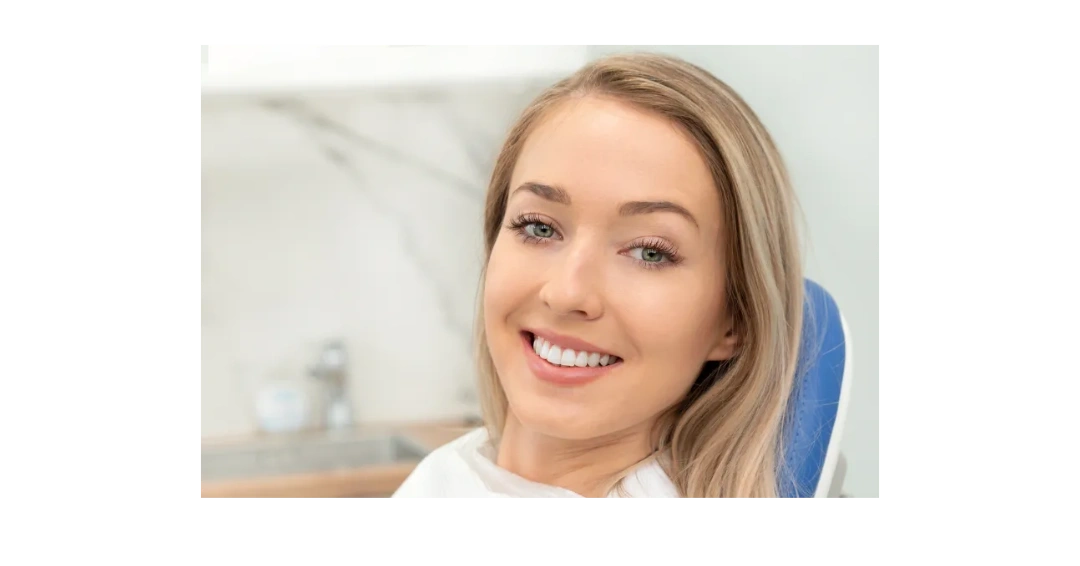 Smiling woman with blonde hair and bright teeth.