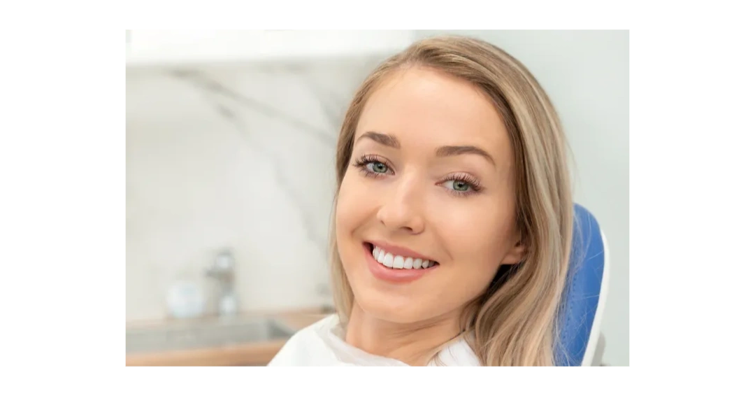 Smiling woman with blonde hair and bright teeth.