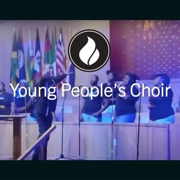 Young People's Choir performing on stage with flags in the background.
