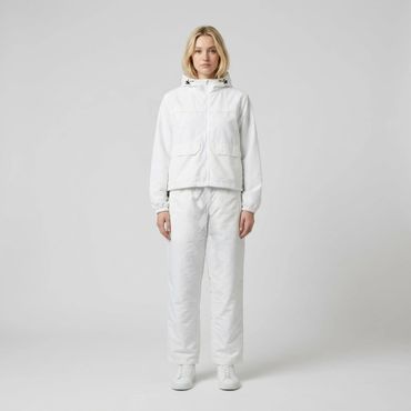 Woman dressed in an all-white casual outfit with a hooded jacket and pants.