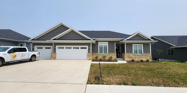 Gold Shield Inspections truck parked outside a modern Eastern Iowa home during a pre-listing home in