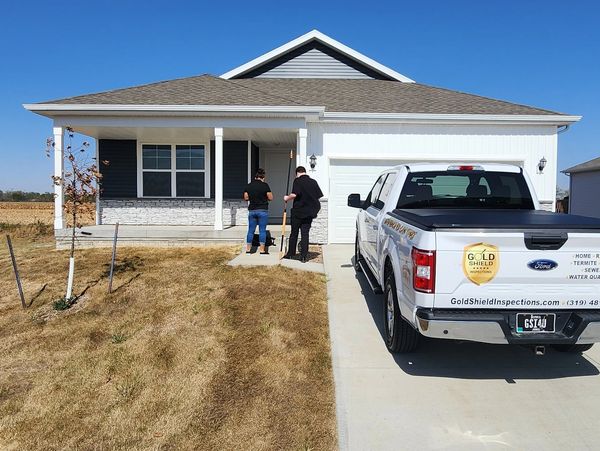Gold Shield Inspections inspectors arriving at a modern Eastern Iowa home to perform a professional