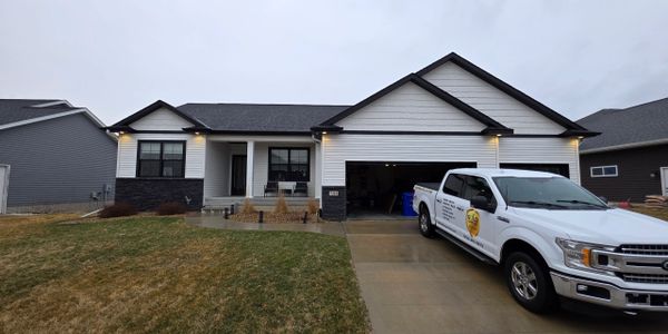 Gold Shield Inspections truck parked outside a modern Eastern Iowa home during a pre-listing home in