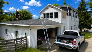 Professional roof inspection being performed to evaluate roofing materials, drainage, and exterior c