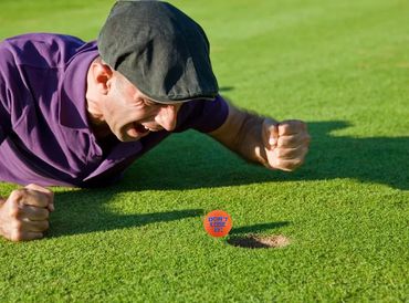 Happy golfer watching the ball goes to the hole