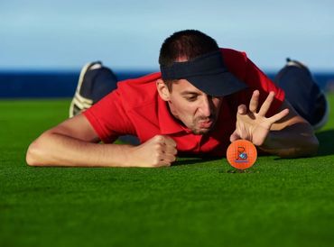 Golfer picking the golf ball