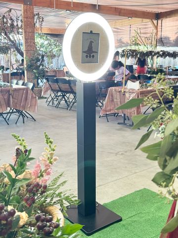 Photo booth with ring light in an outdoor setting.
