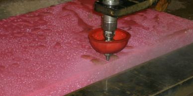 Industrial cutting of 3" thick UHMW plastic by the OMAX waterjet in Stevensville, MT.
