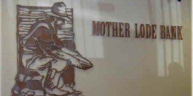 Rusted signs like this one create an aged look to a wall.  Courtesy, Mother Lode Bank in Sonora, CA.