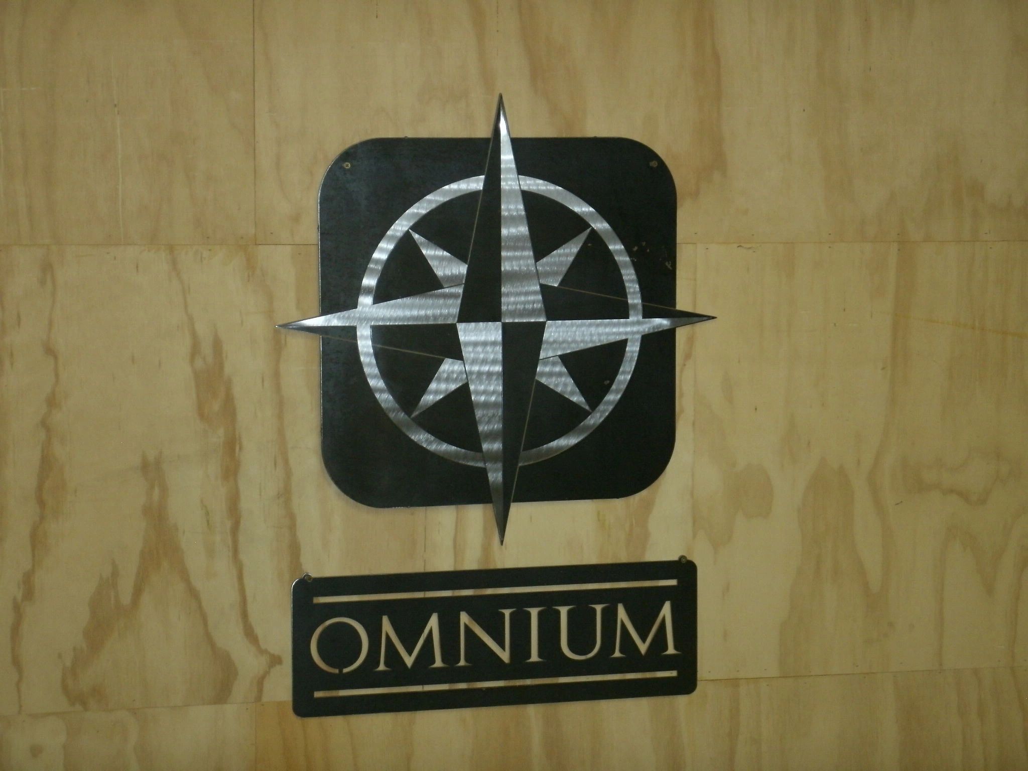 Custom business sign made from stainless steel and plain steel.