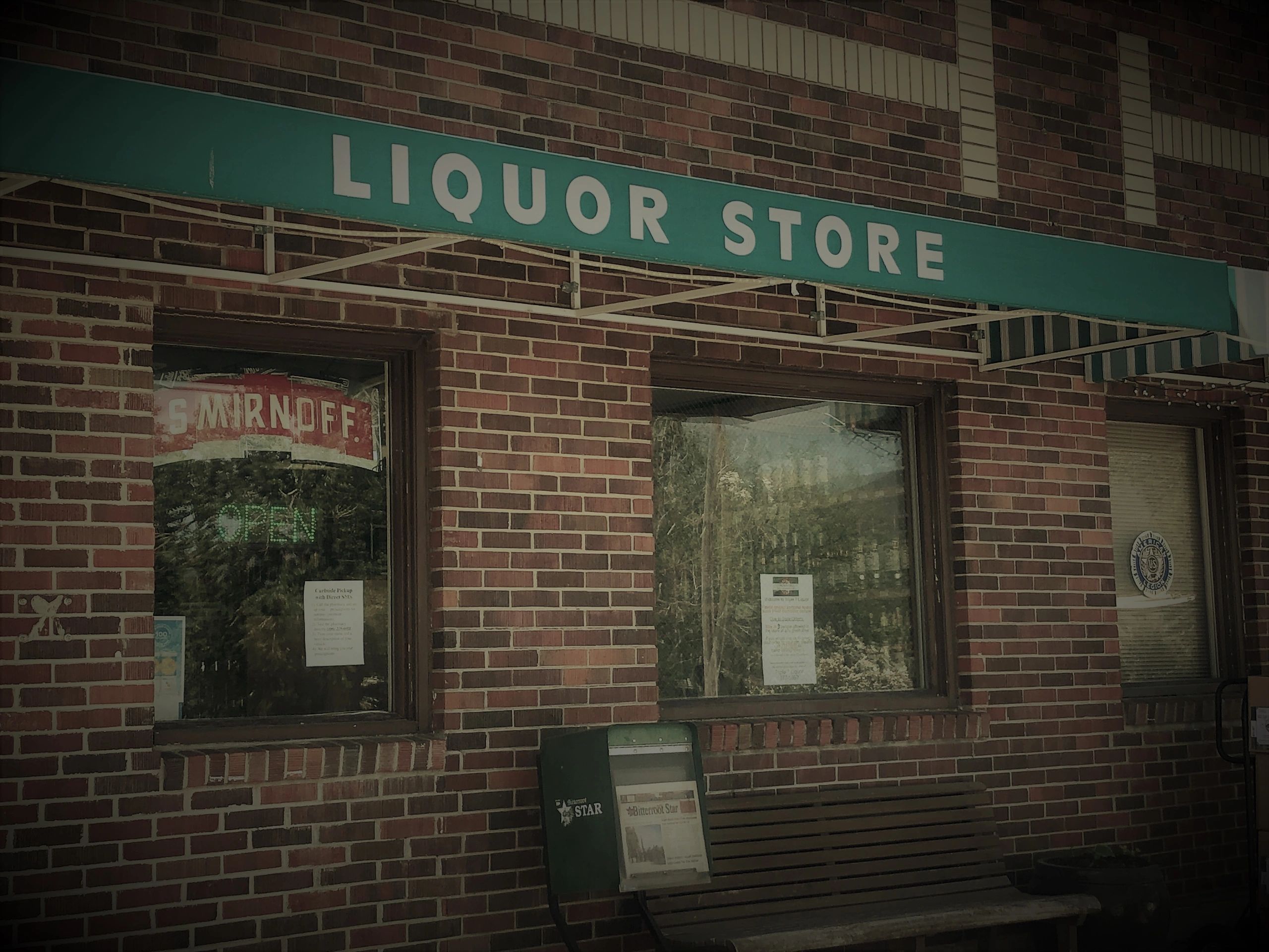 outside view of triple 7 liquor on main street stevensville montana. sign above door says liquor sto