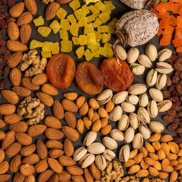 Assorted dried fruits and nuts arranged in a colorful pattern.