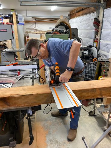 Lazy iBuilds "Bob" sawing the mantle wood extrusion into three sections using the track saw.