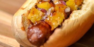 Jumbo hotdog on a bun with fried onions and corn relish