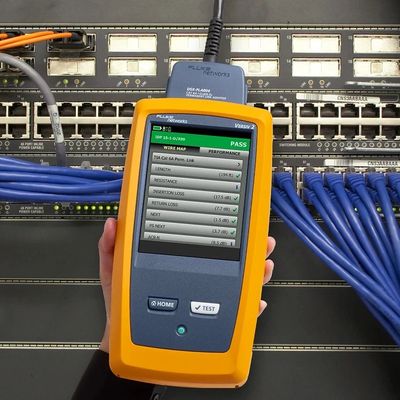 Fluke DSX Versiv 2 Tester and cable certifier. Yellow device with LCD touchscreen for testing.
