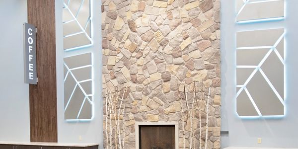 The birch trees and corporate logo of Elmbrook Church subtly incorporated into the narthex gathering spaces - Brookfield, WI
