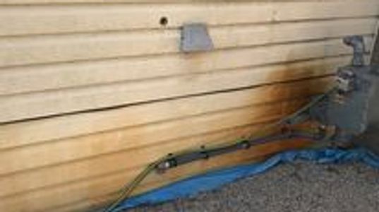 Before vinyl siding with heavy rust staining