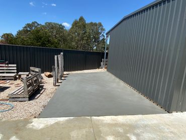 Concrete slab beside a shed