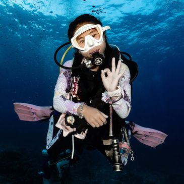 Scuba diver underwater giving an OK hand signal.