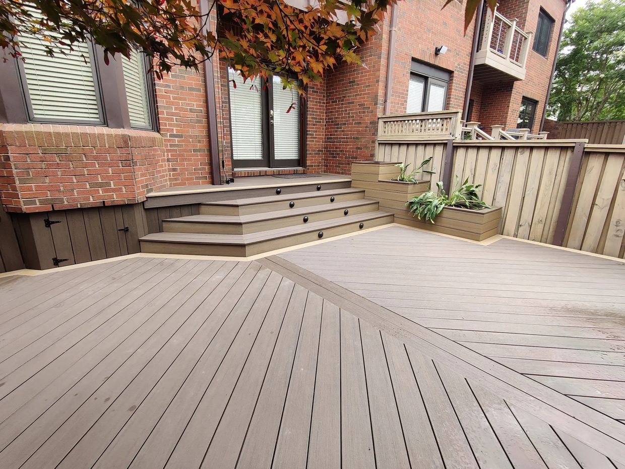 Composite decking on a diagonal pattern with accent boarder, Layered stairs & planter boxes.